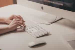 Someone typing on Mac computer