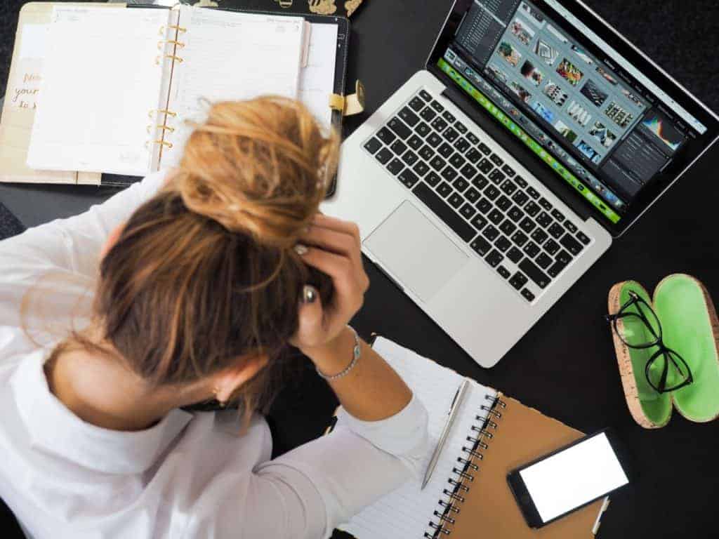 Frustrated student working on laptop