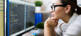 Close up of a smart young woman coding